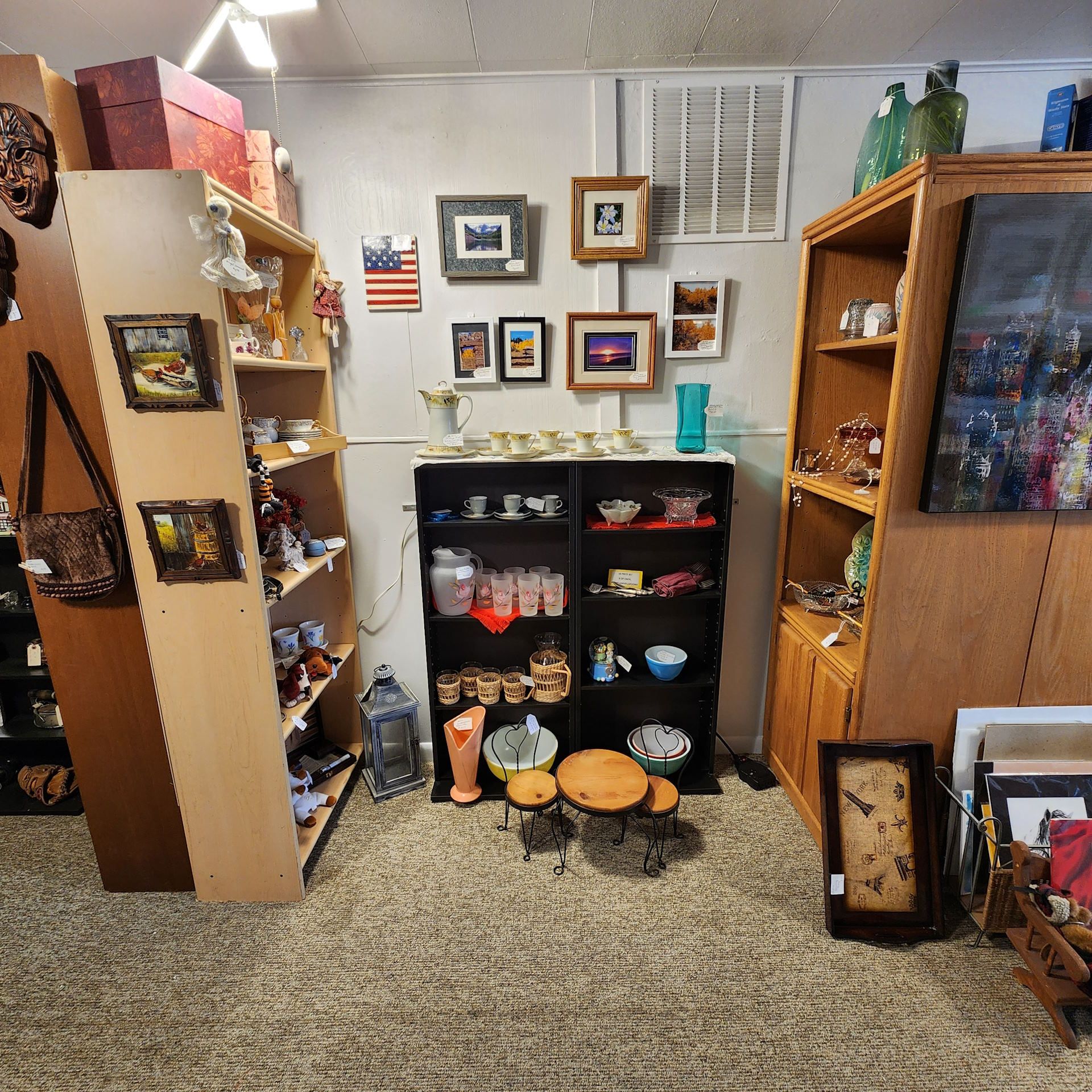 A room with a lot of shelves and pictures on the wall