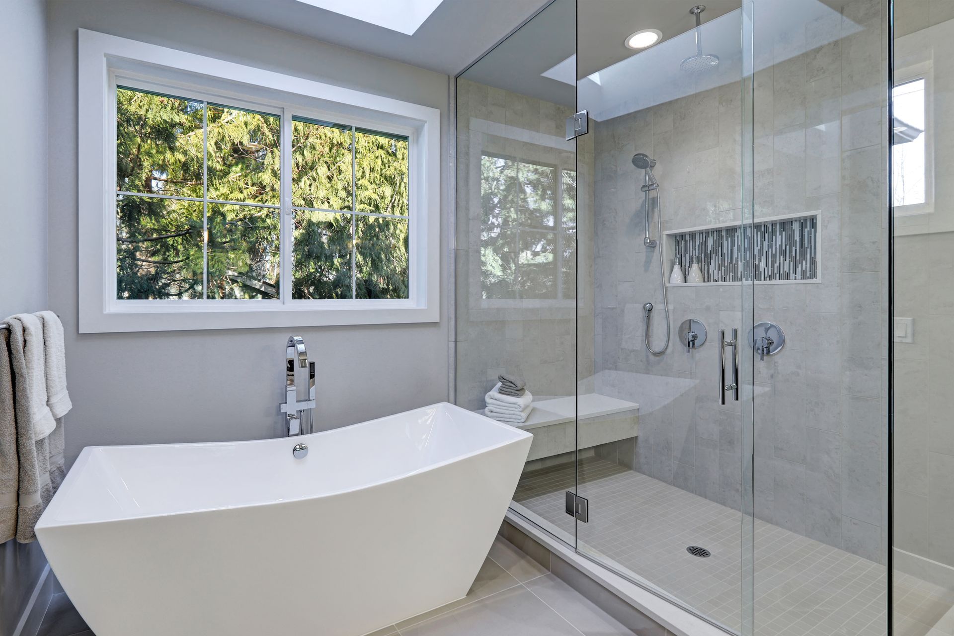 Modern bathroom with a tempered glass shower enclosure.