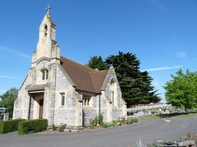 Small stone church with a steeple under a blue sky