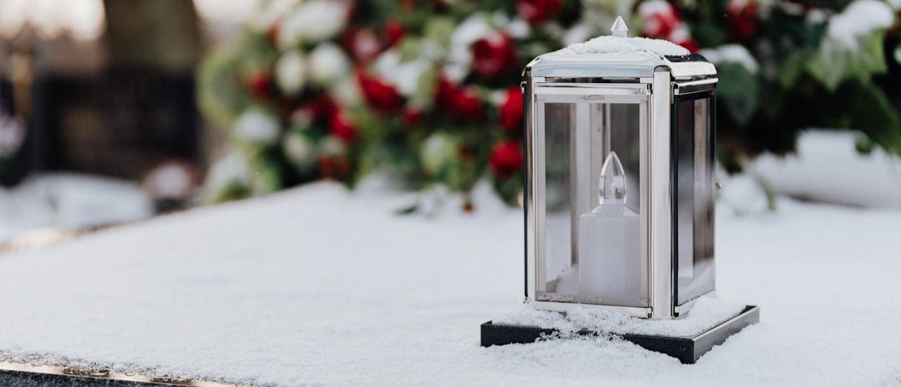 Lamp on snow in a cemetery