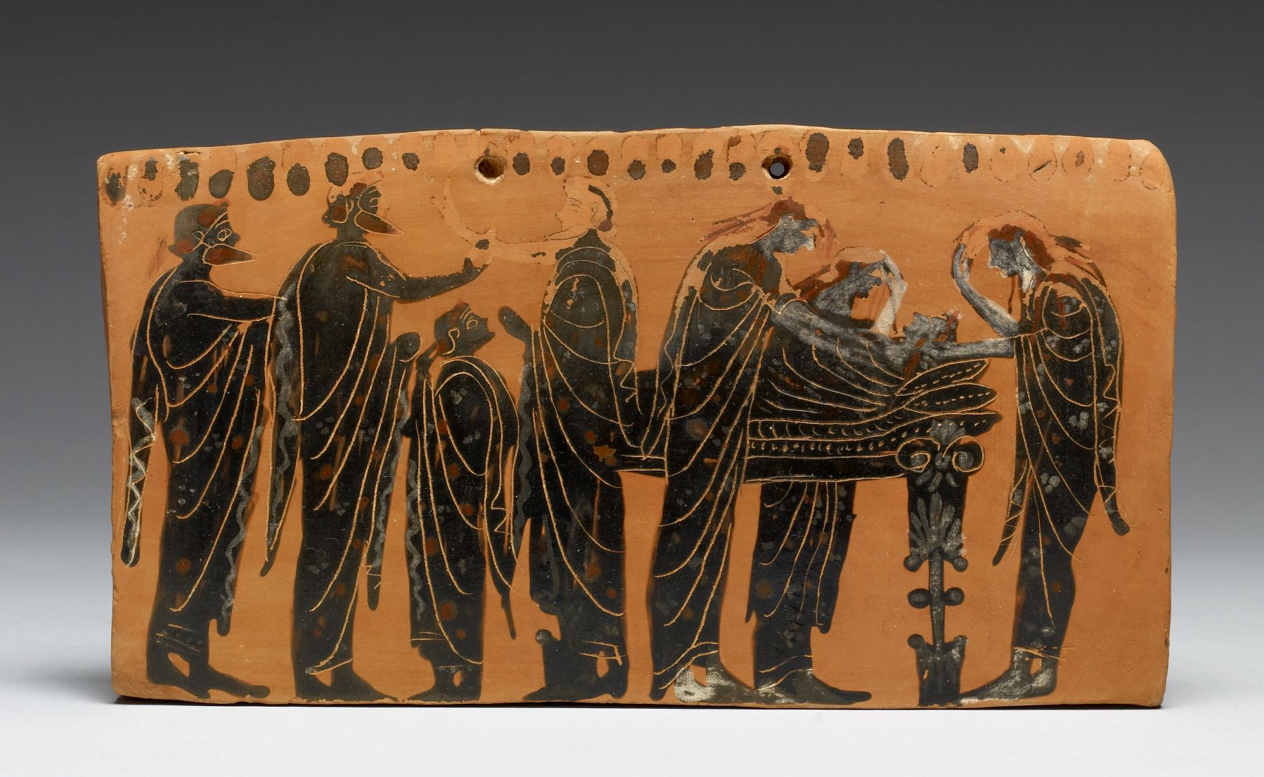 Pinax plaque made terracotta, showing a 'prothesis' scene, the lying-in-state of the deceased on a bed, surrounded by his family members