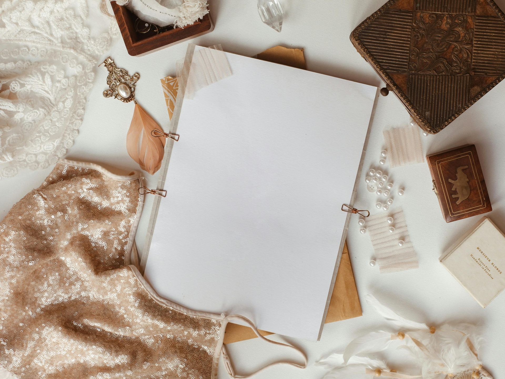 A blank scrapbook surrounded by precious keepsakes