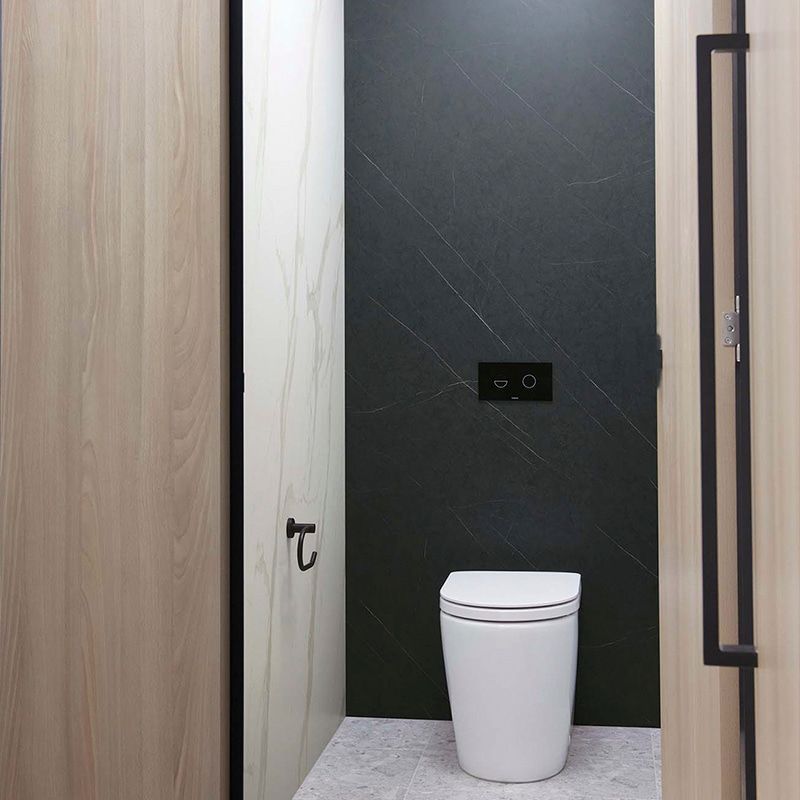 A Toilet is Sitting in a Bathroom Next to a Door — The Right Toilet Co In Unanderra, NSW