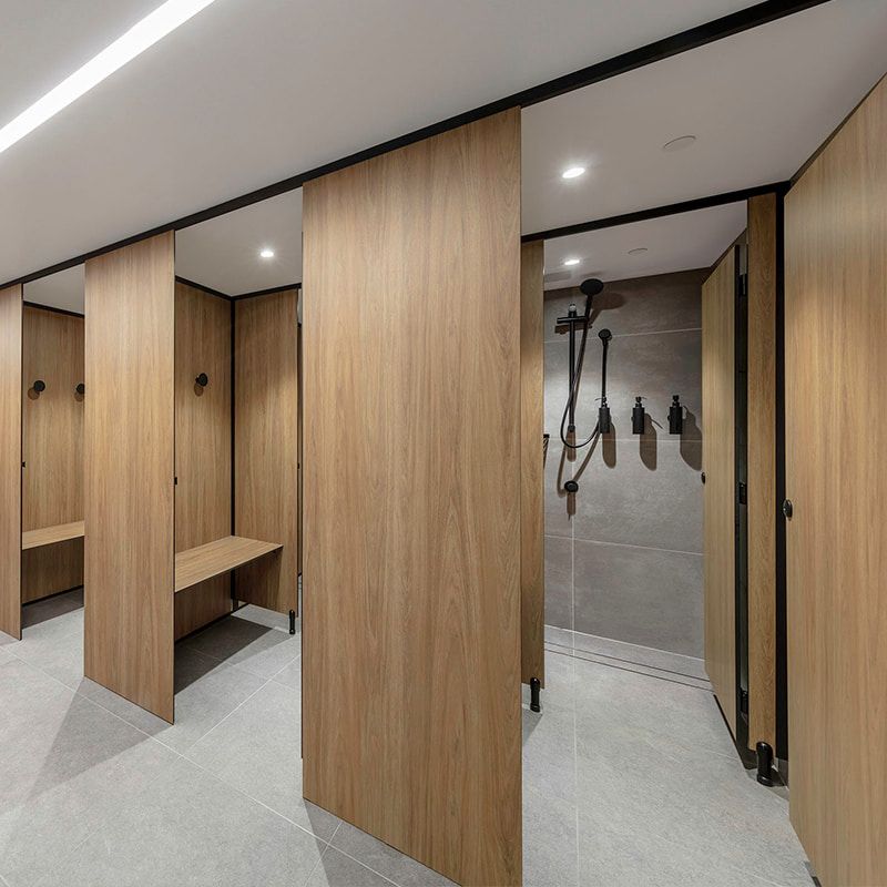 A Locker Room With Wooden Walls and a Bench — The Right Toilet Co In Unanderra, NSW