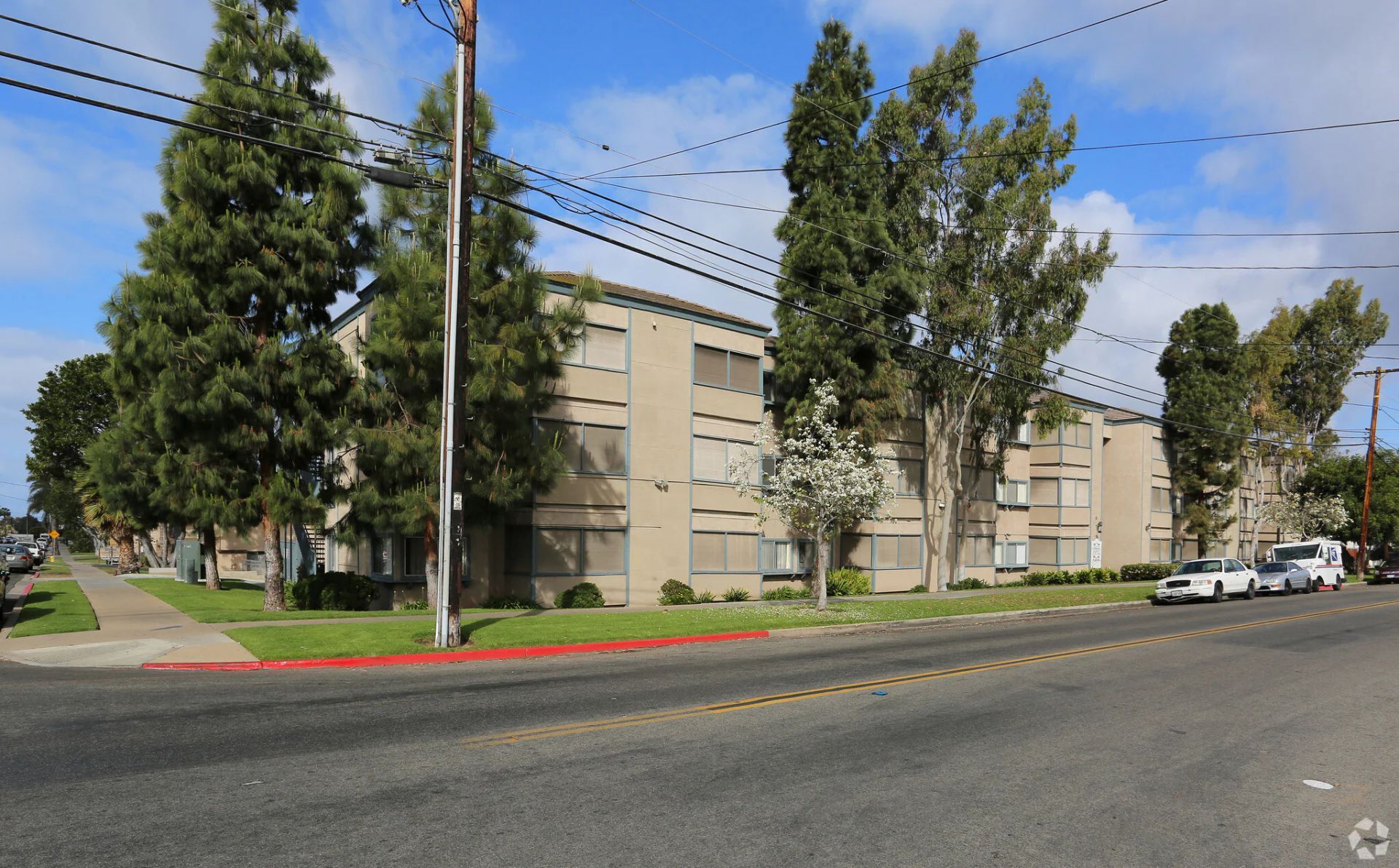 Photo of a three story apartment building, seen from across the street