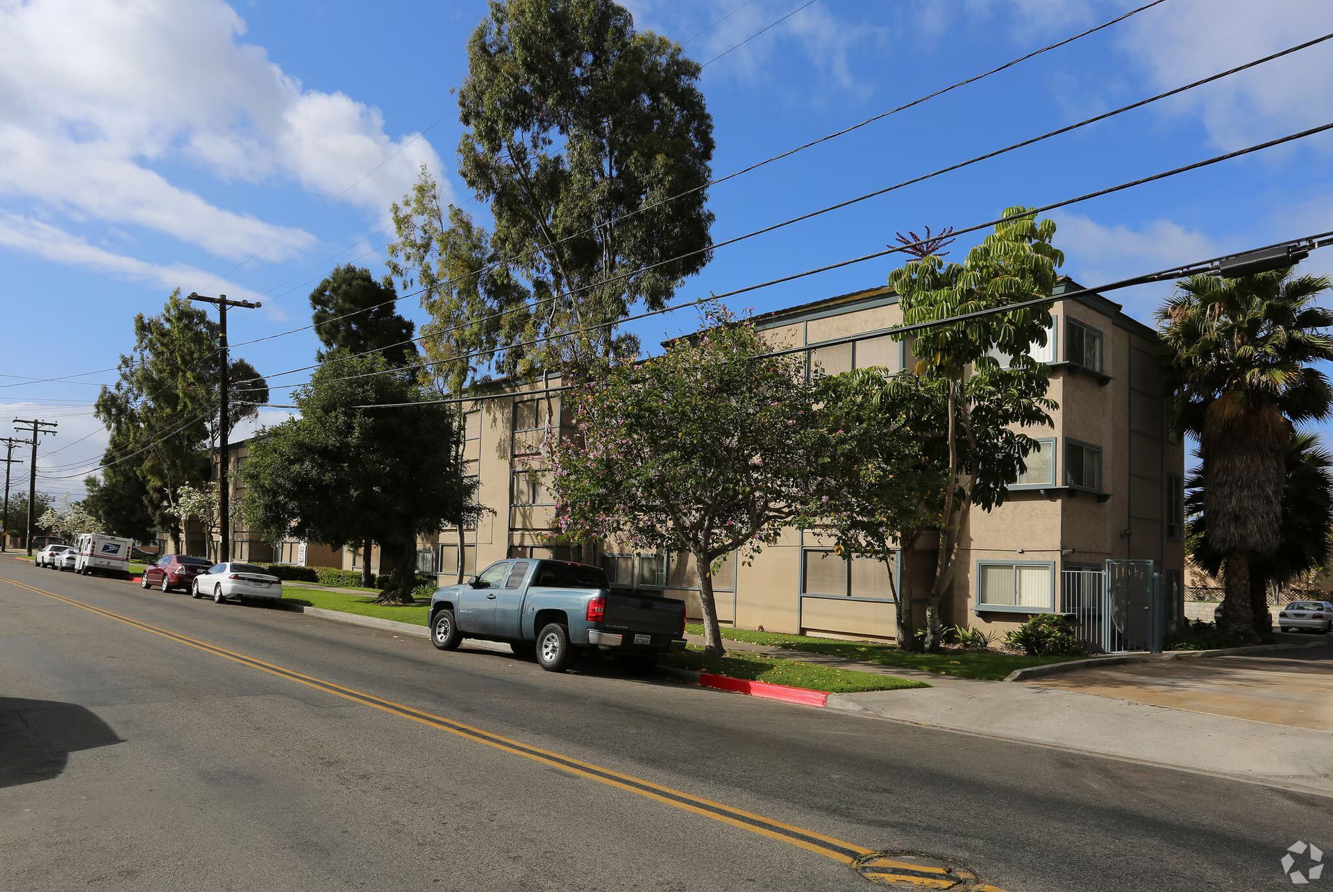 Photo of a three story apartment building, seen from the street