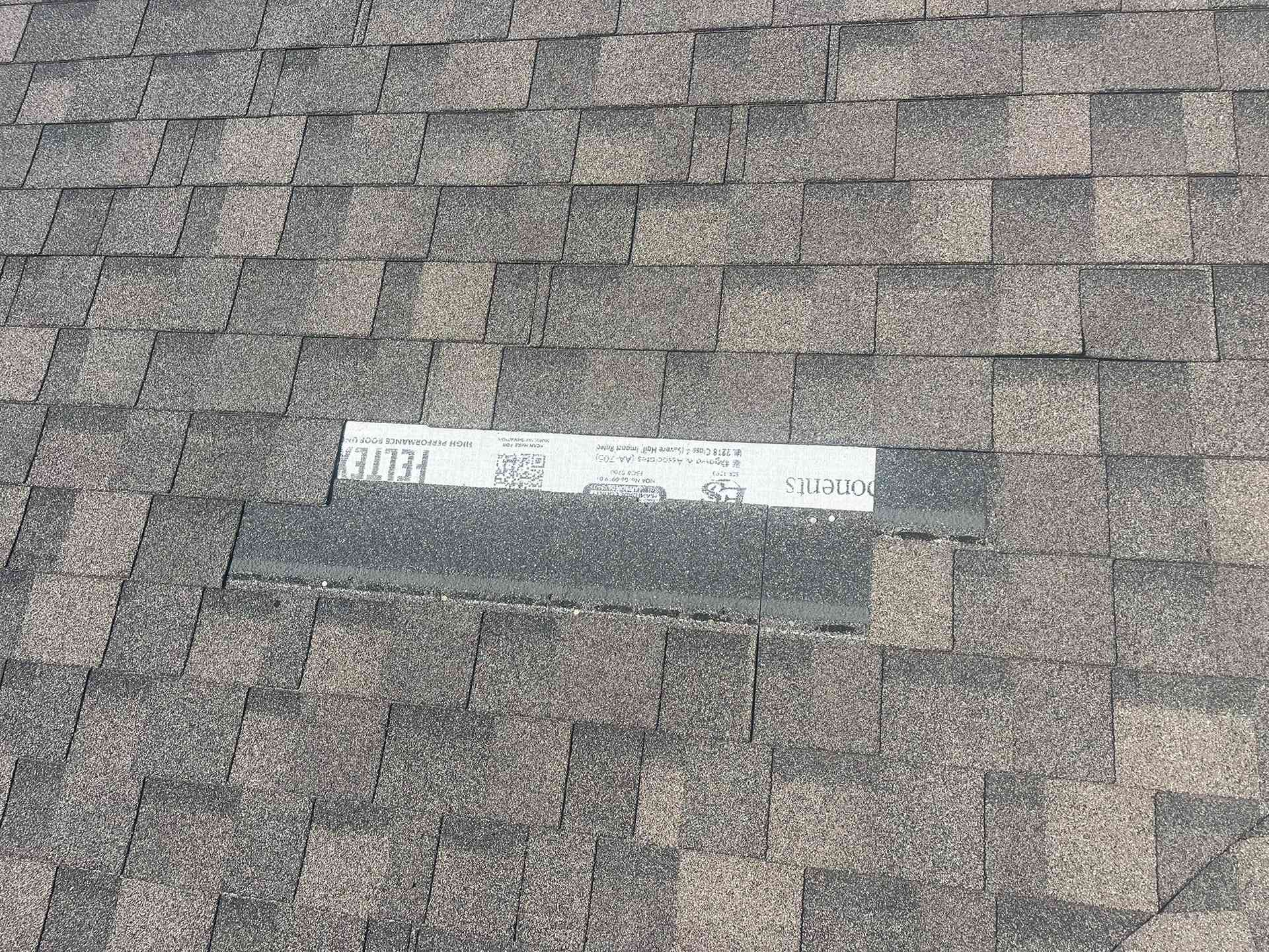 Shingled roof with a white rectangular vent or label near the center.