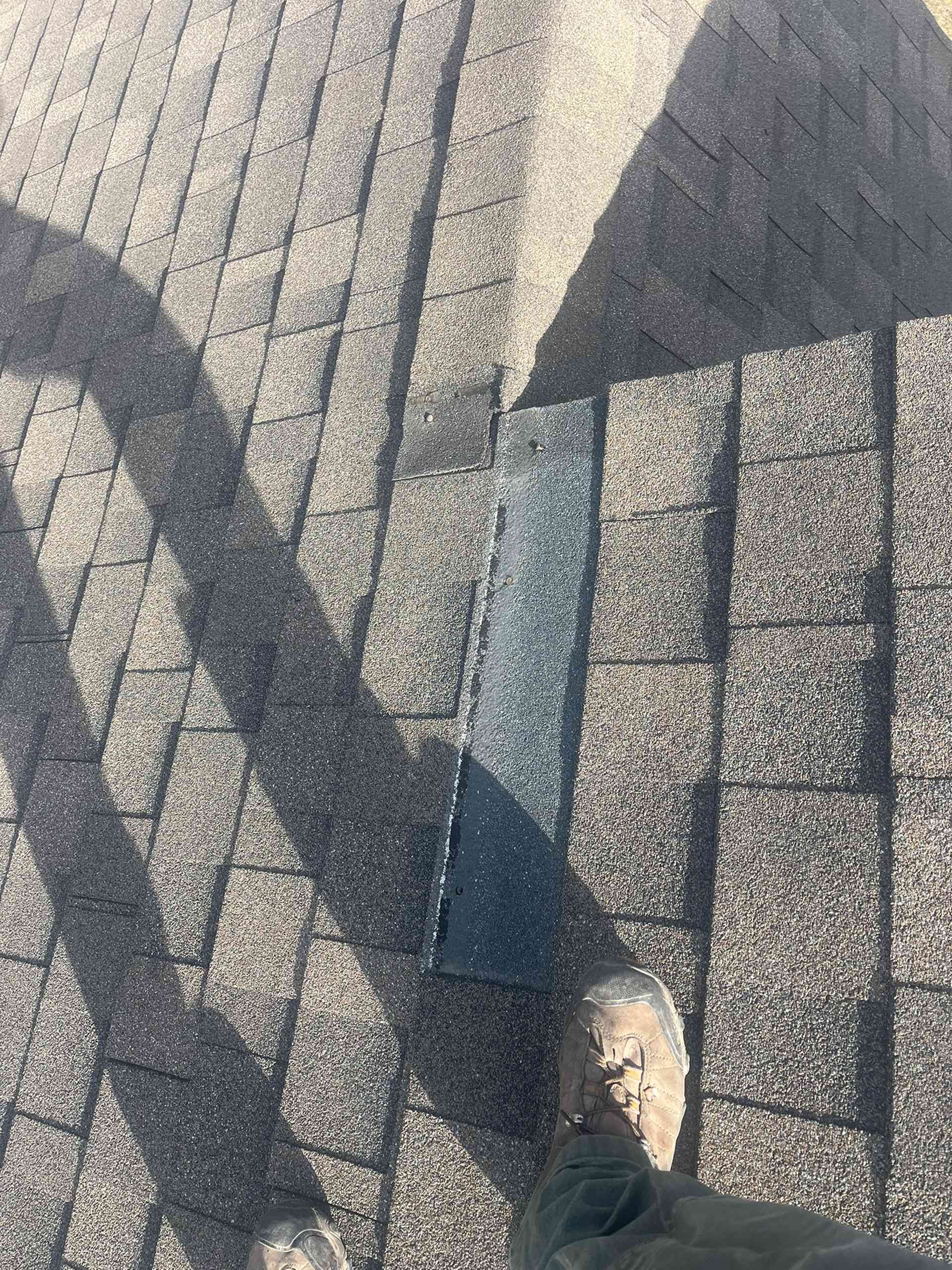 Shoe on a gray textured pavement with long diagonal shadows
