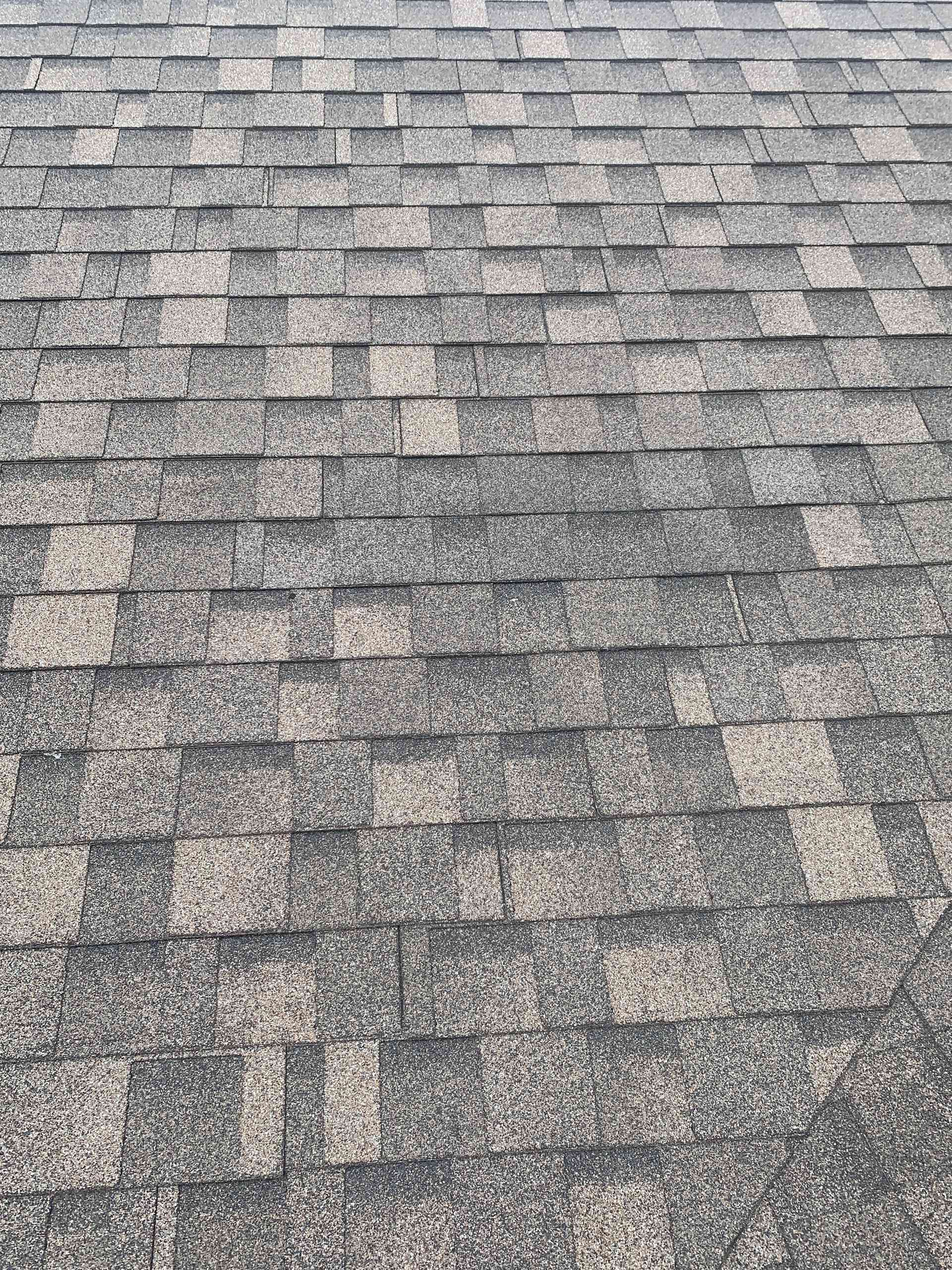 Gray asphalt shingle roof with a uniform, weathered pattern