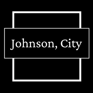 White outline sign on black background reading “Johnson, City”