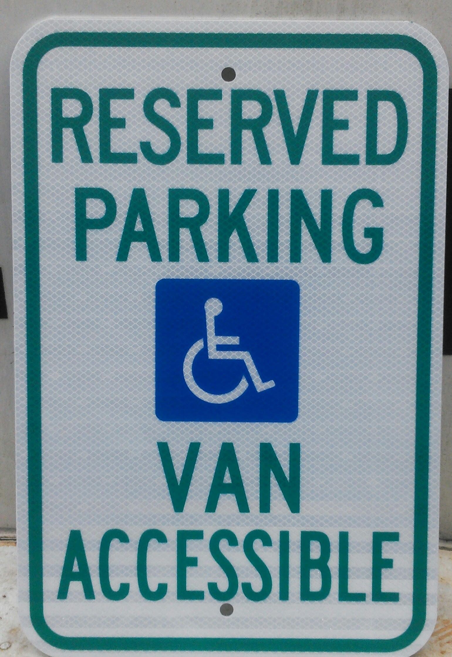 A sign that says reserved parking and van accessible