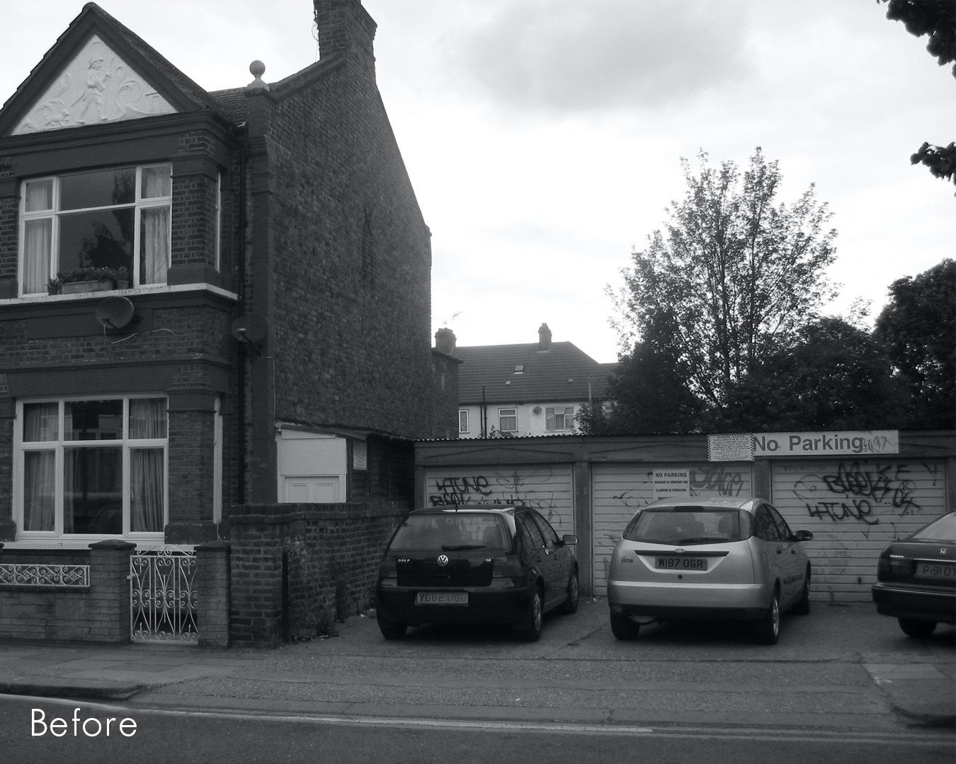 Black-and-white street view of a brick house, parked cars, and a graffiti-covered wall with “Before” text.