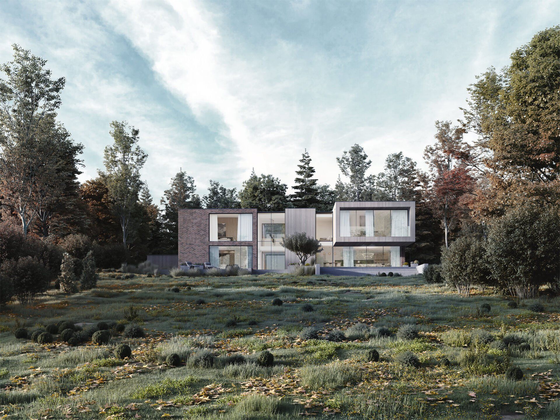 Modern two-story house with large windows in a grassy field, framed by trees under a cloudy sky