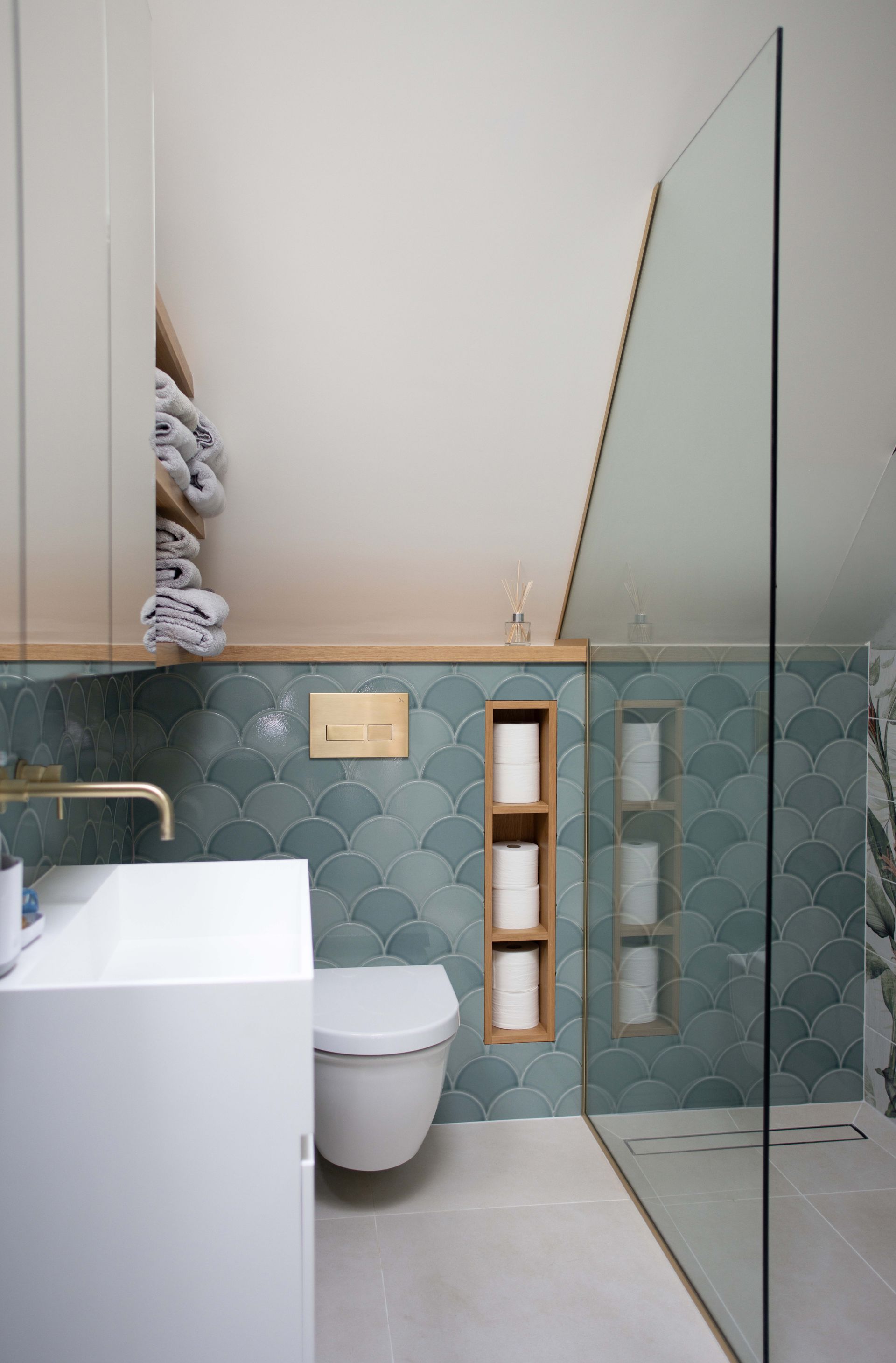 Bright minimalist bedroom with open glass doors leading to a tiled bathroom or hallway at the back