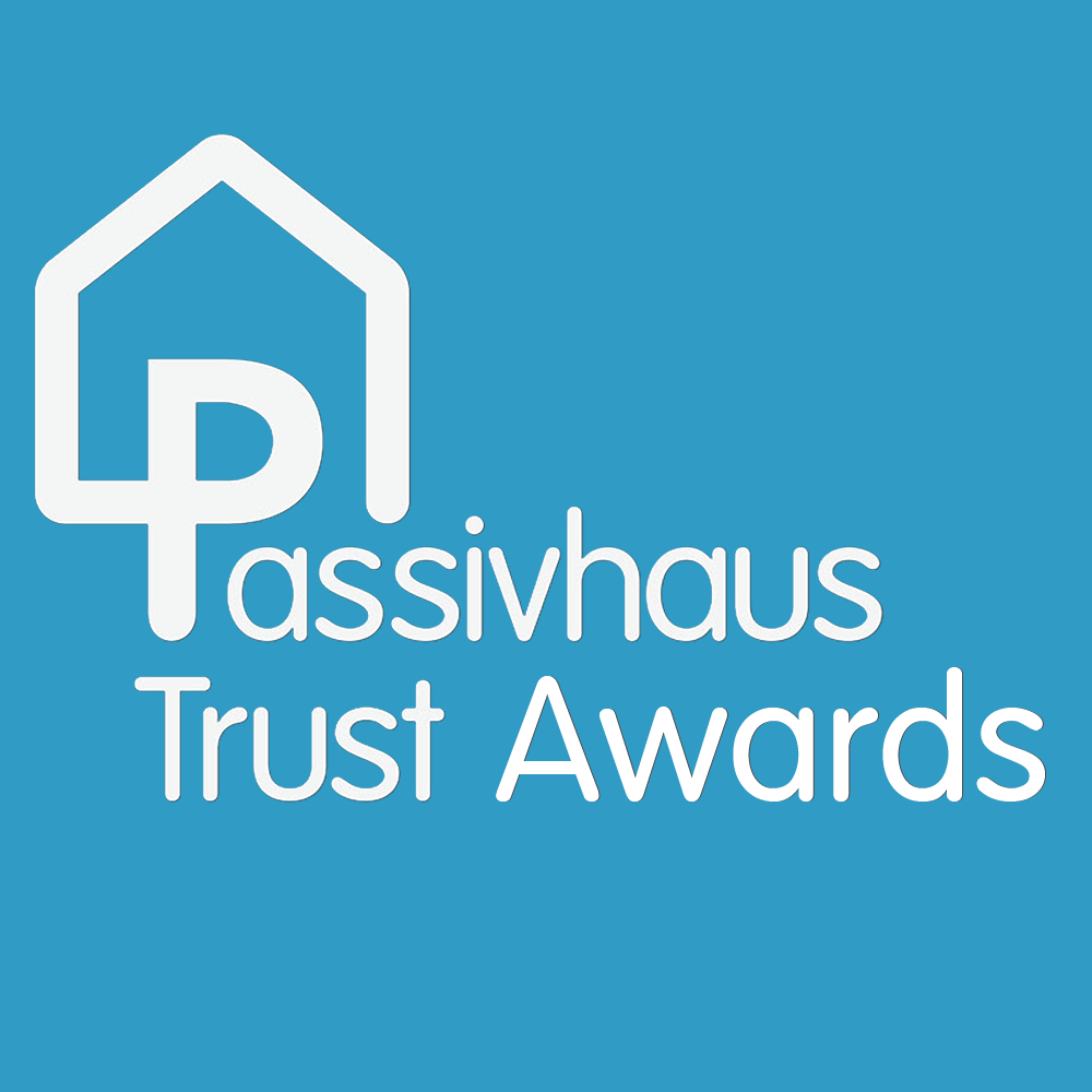 Logo for Passivhaus Trust Awards on a teal background. The logo features a house outline over the letter 