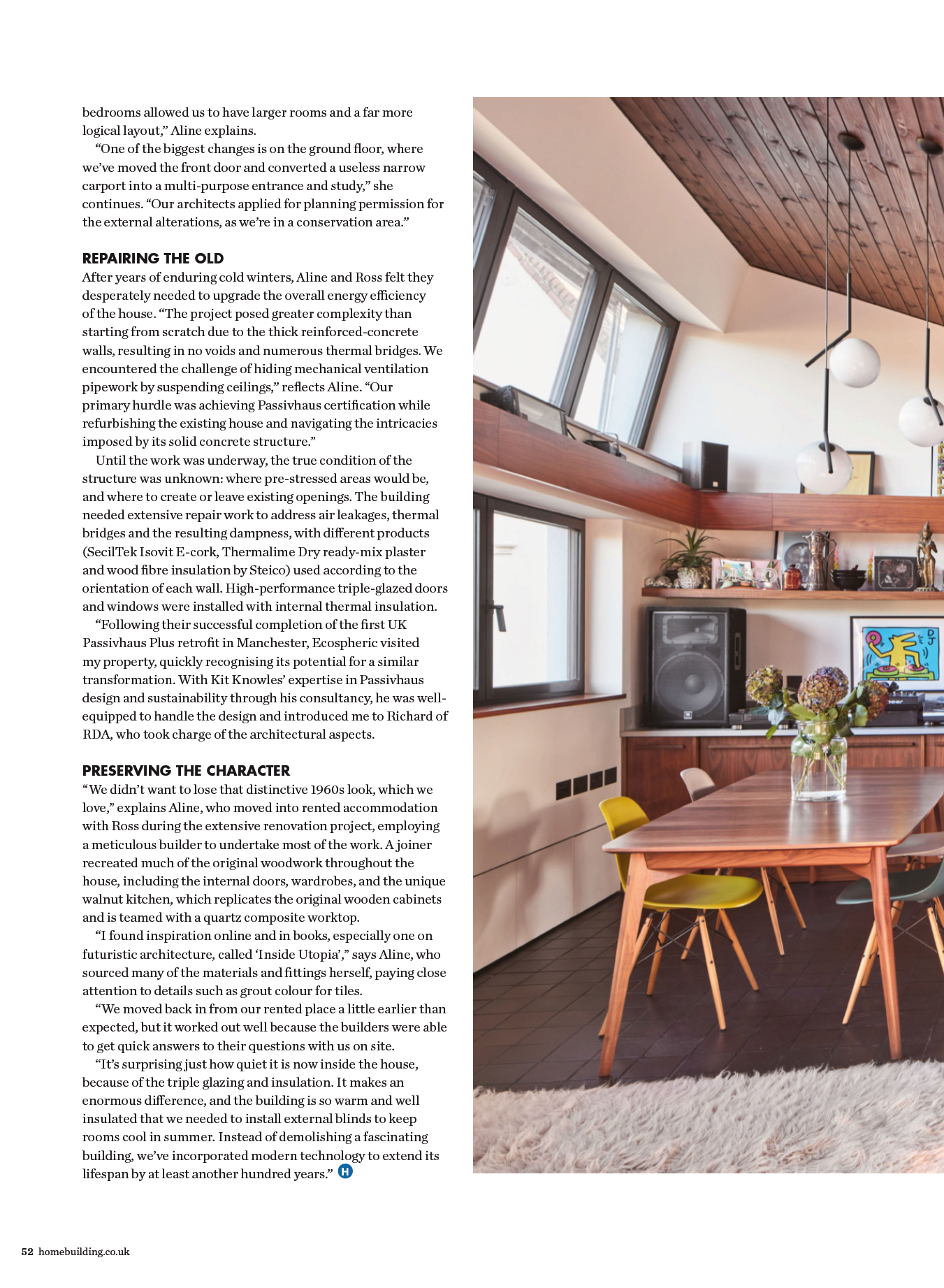 Modern dining area with wooden table, chairs, pendant light, shelves, and large windows with a slanted wood ceiling