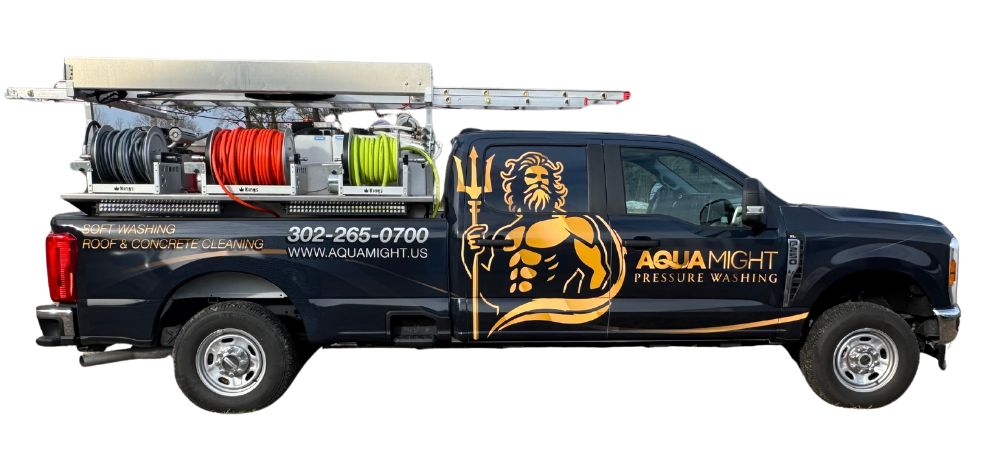 Dark blue truck with a pressure washing setup and the logo
