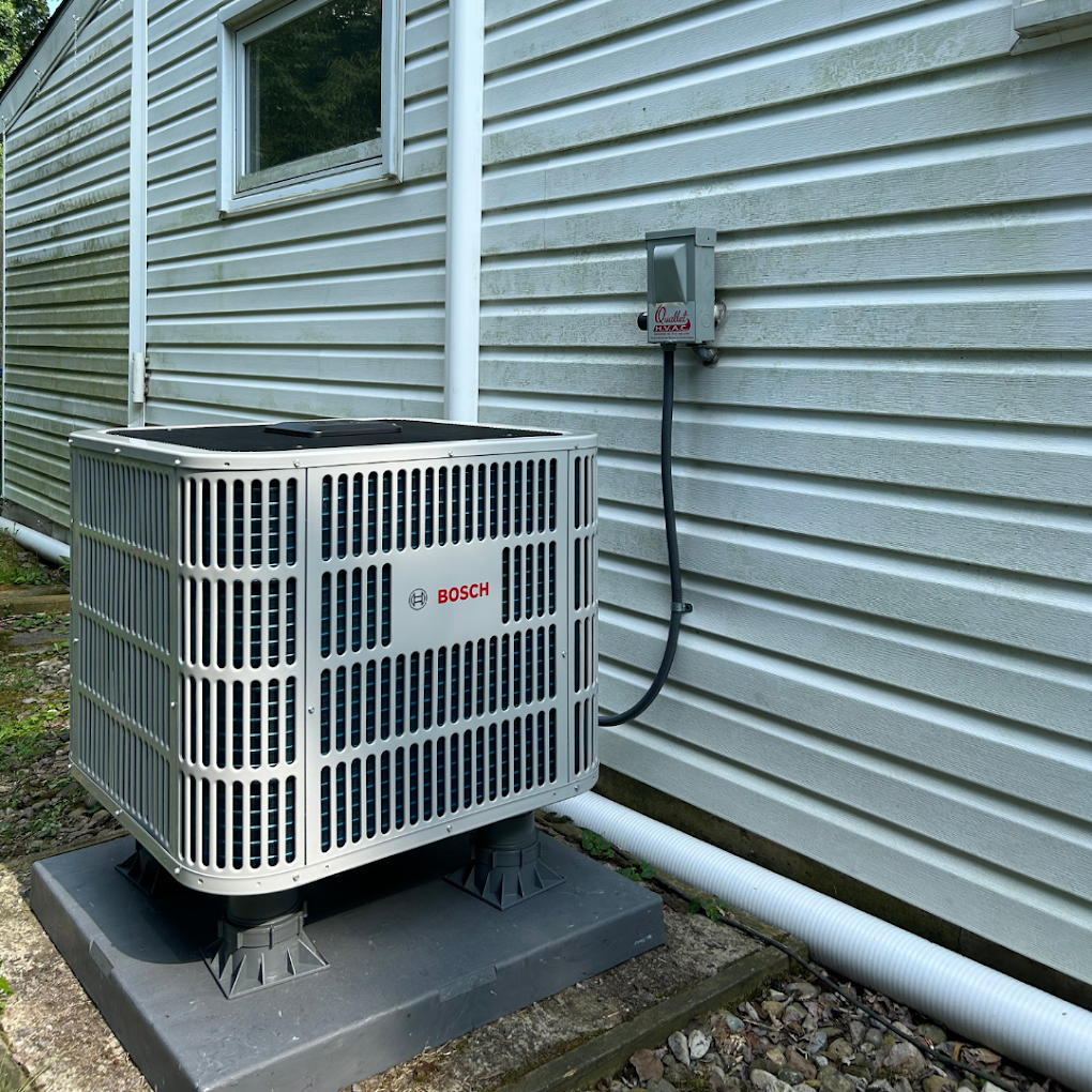 A bosch air conditioner is mounted on the side of a house