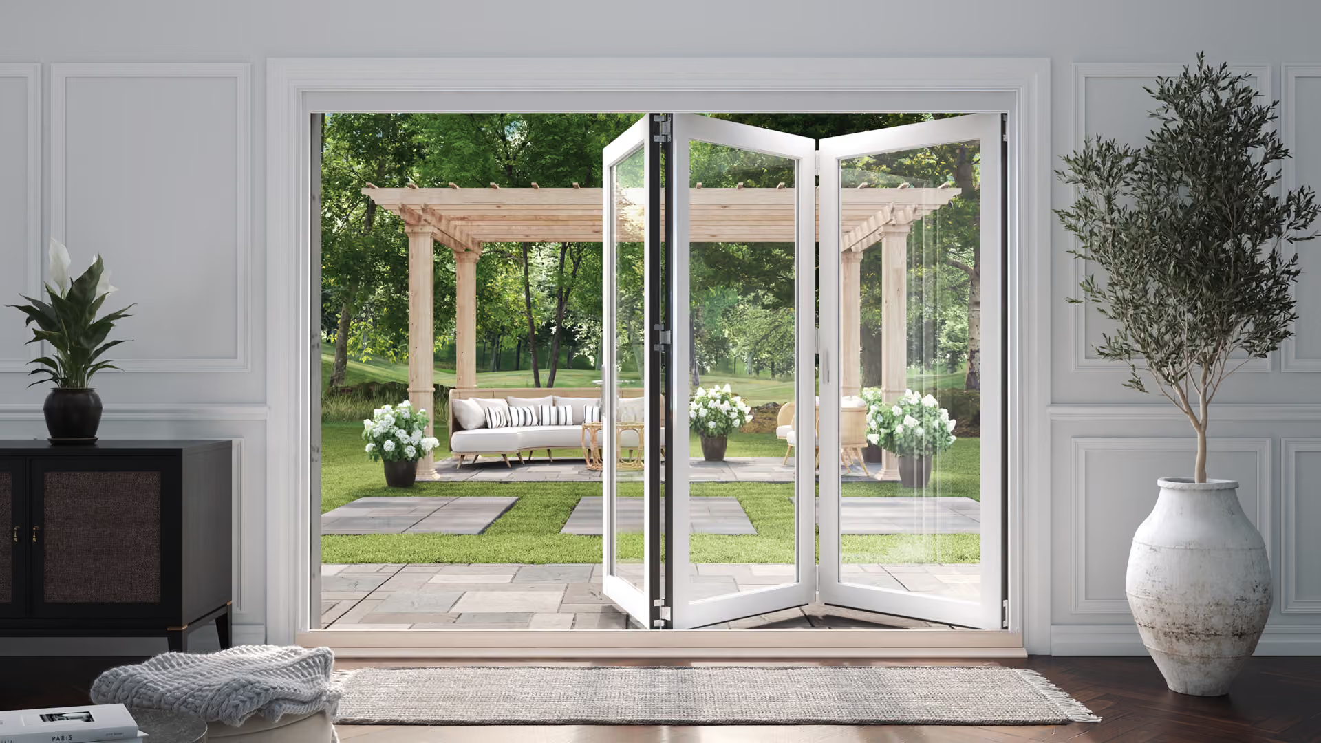 Bright living room with open glass doors leading to a garden pergola and patio seating