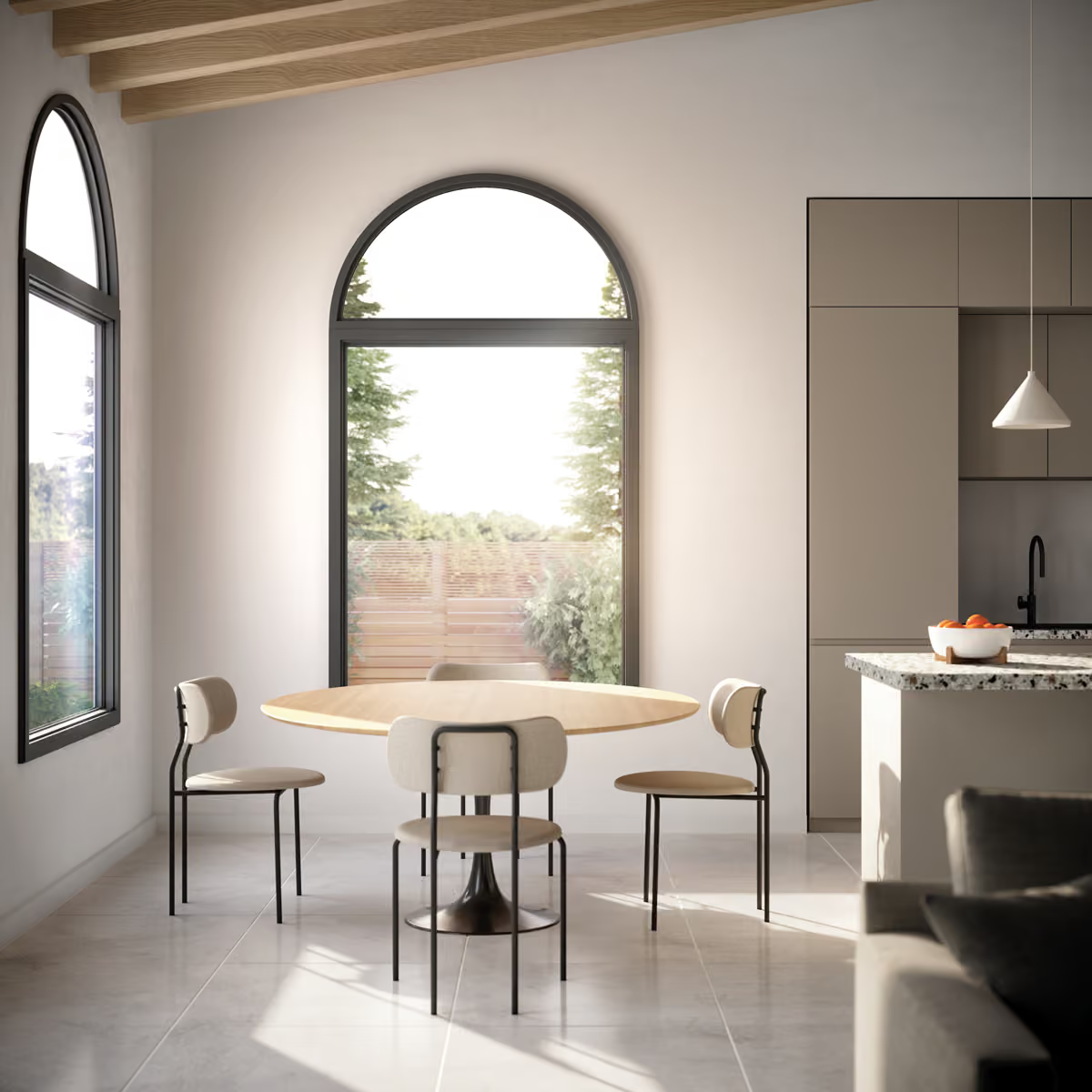 Minimalist dining area with round table, three chairs, arched windows, and a bright kitchen counter.