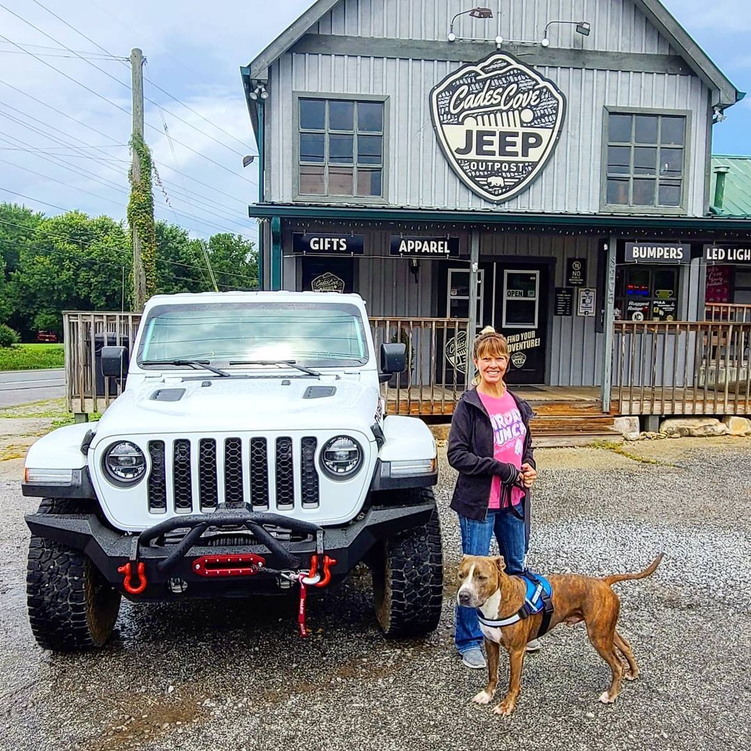 Rubicon Jeep with a woman holding her dog