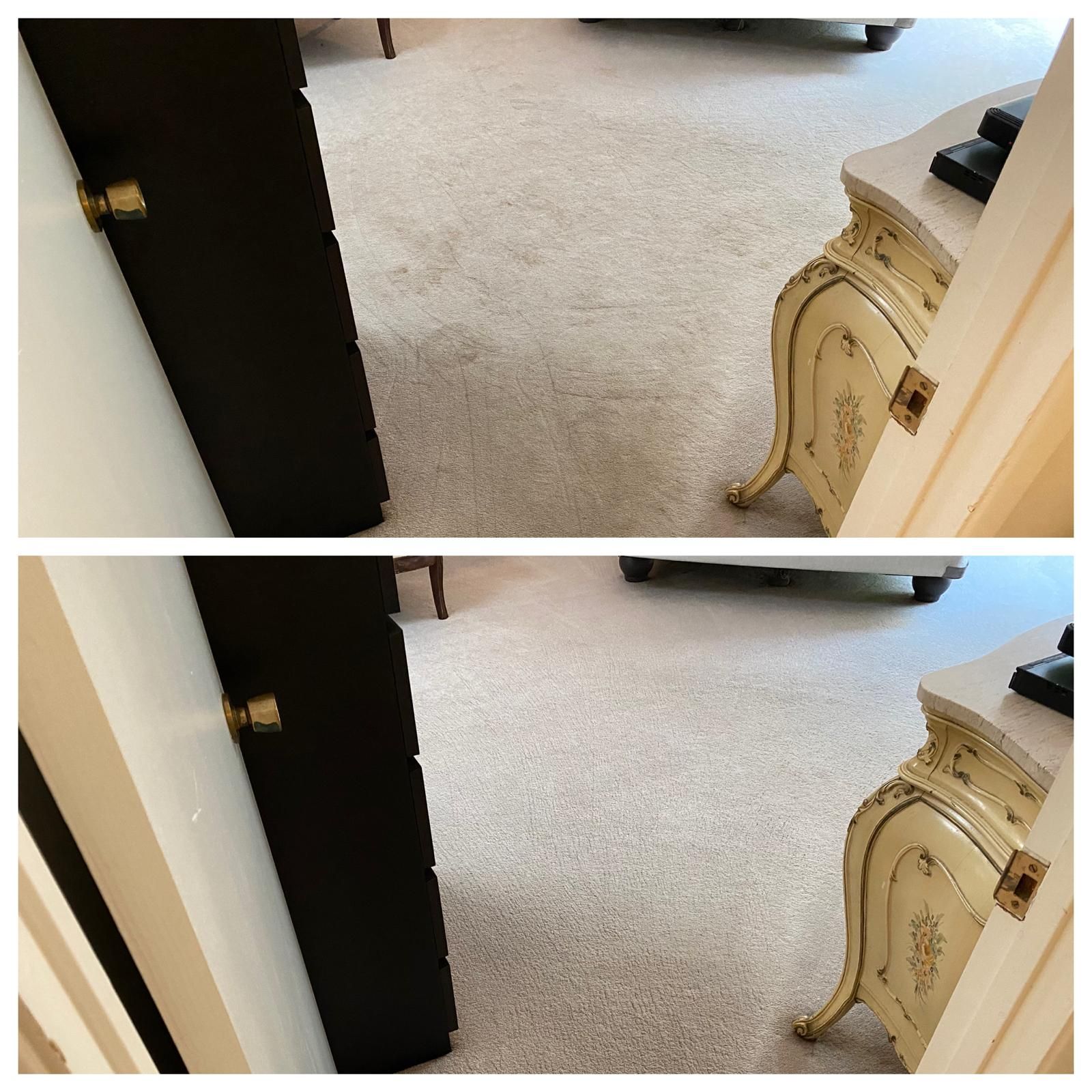 Open doorway into a carpeted room with a small ornate cream table on the right.