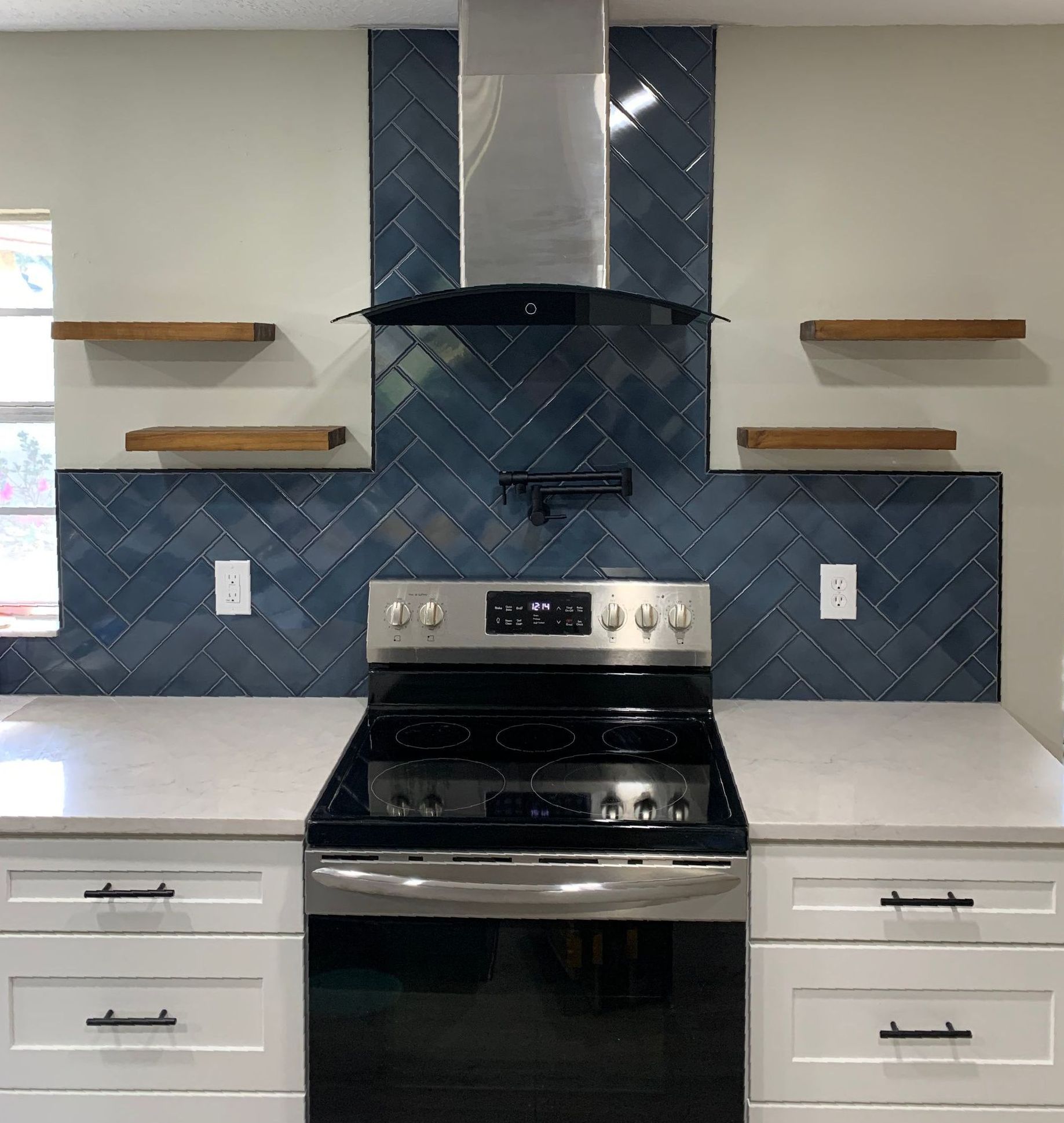 A kitchen with a black stove top oven and white cabinets