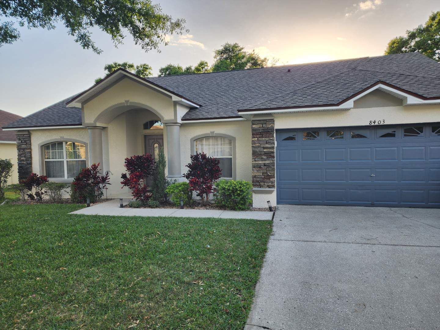 The front of a house with a blue garage door