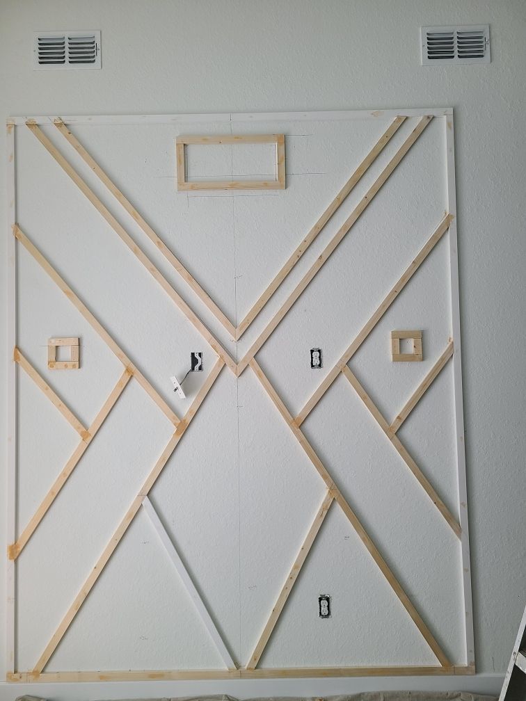 A white wall with a geometric design on it