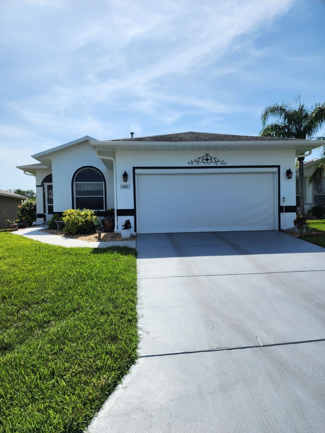 A white house with a large white garage door