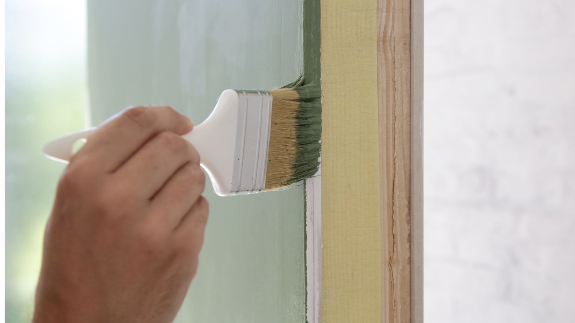 A person is painting a door with a brush.