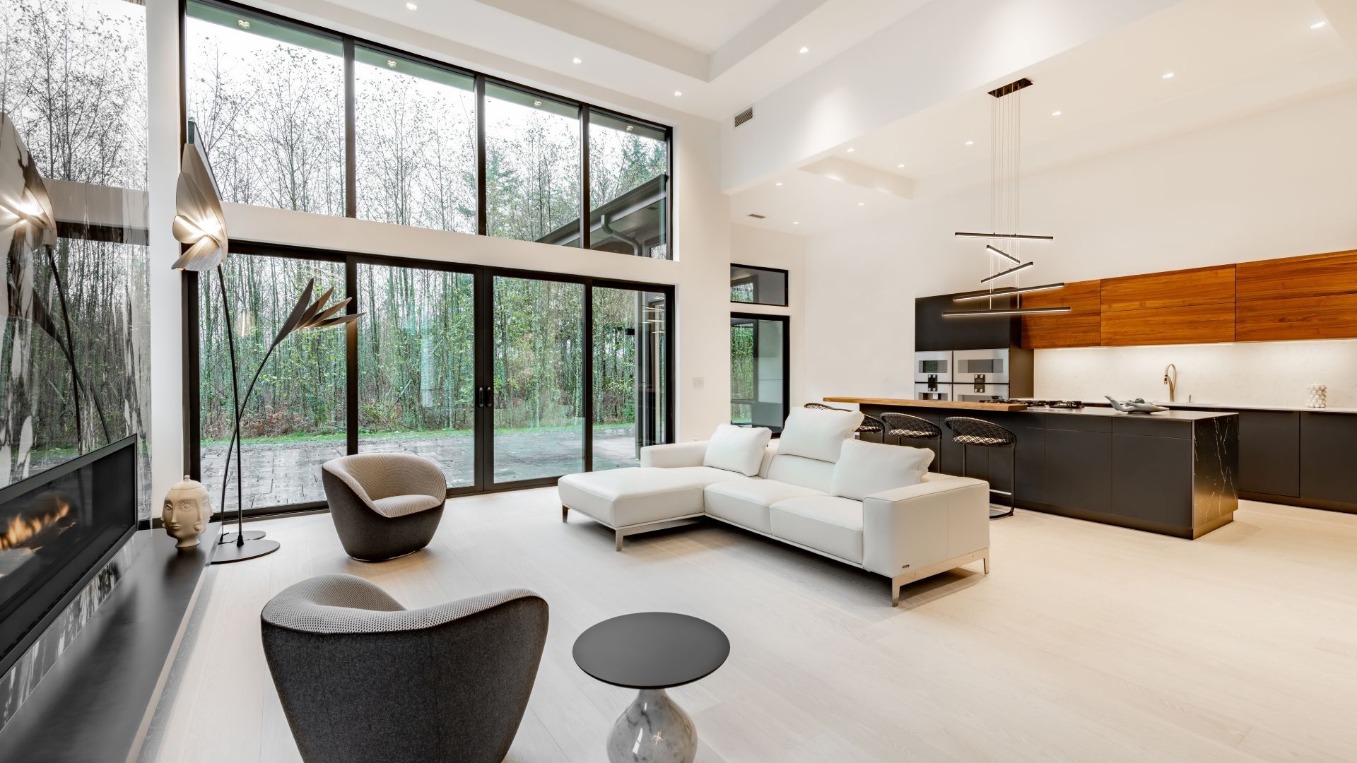 A living room with a couch , chairs , and a fireplace.