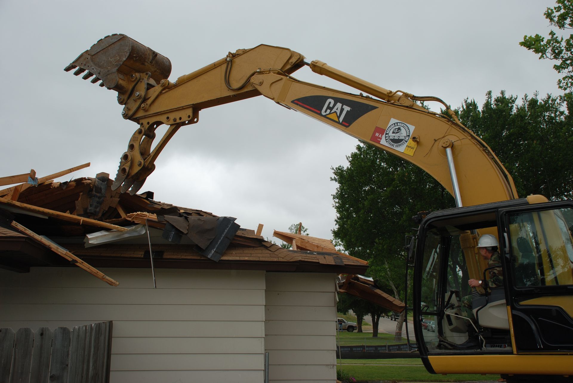 Mini excavator and track loader digging a hole in Roundrock, TX.