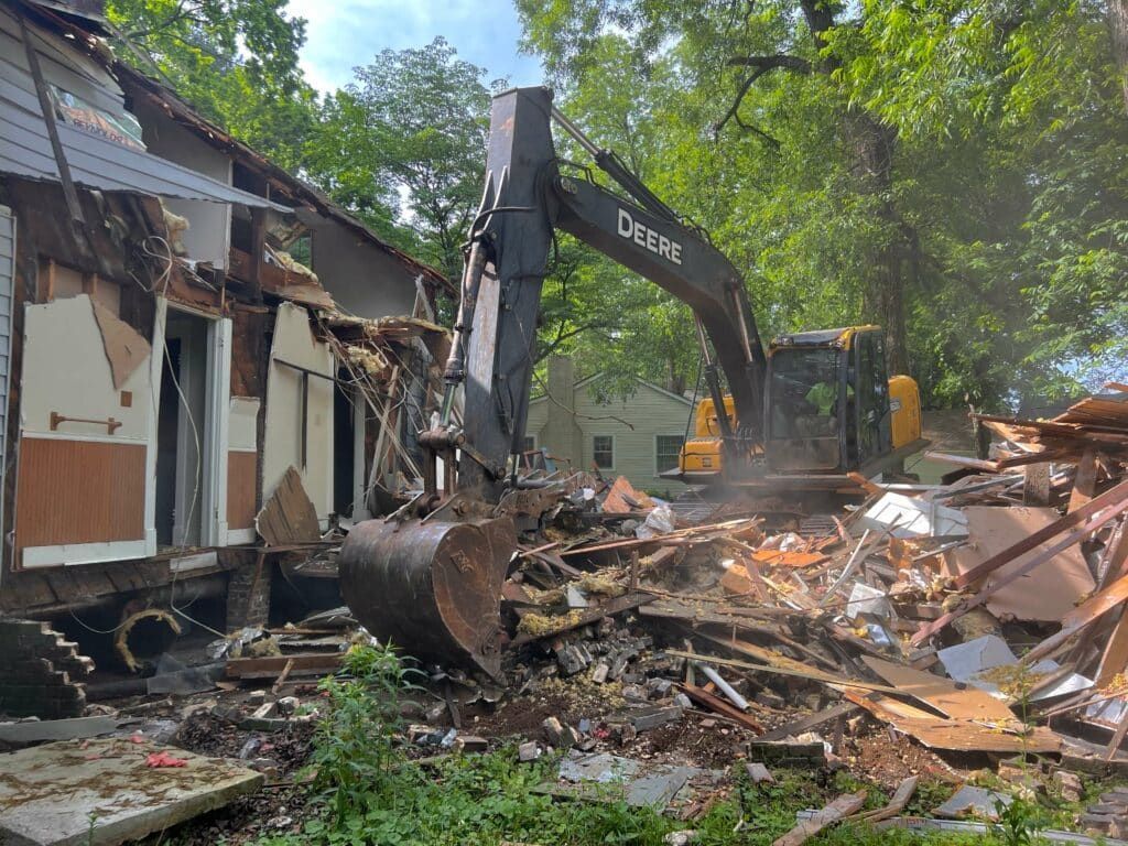 Two bulldozers are parked next to each other in a dirt field.