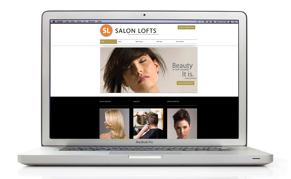 A laptop is open to a website for salon lofts