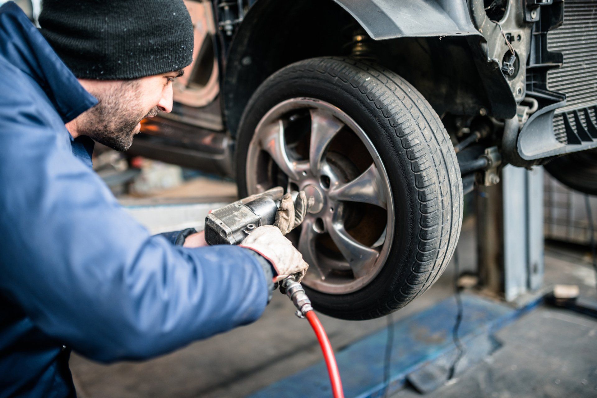 Man Changing The Car Tire — Geelong VIC — Auto Express Service Centre & Mobile Mechanics