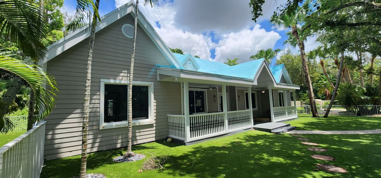 Gray home exterior with a covered porch and white trim
