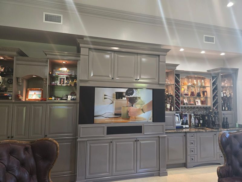 Gray painted built-in cabinetry with glass-front upper doors