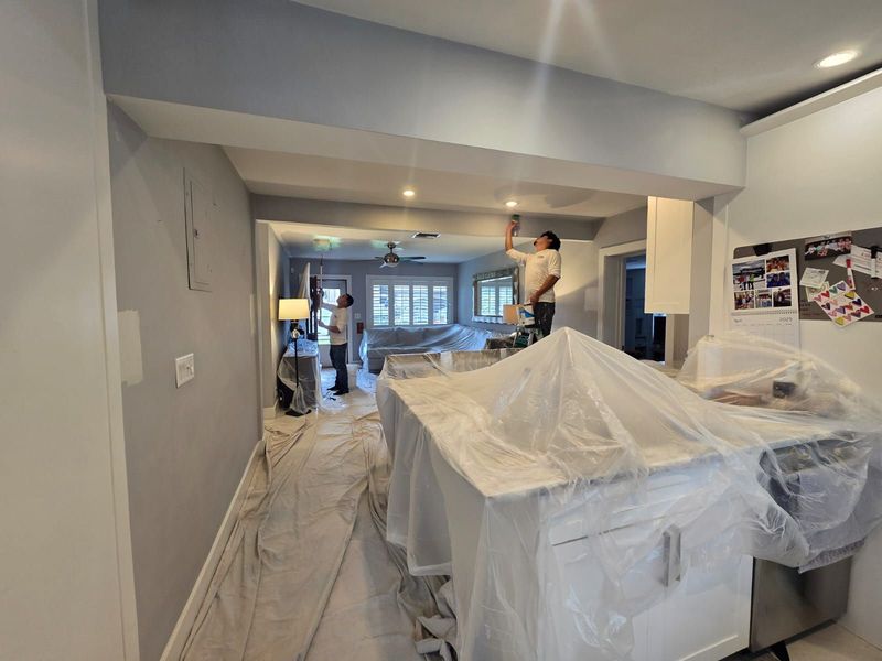 Furniture and surfaces protected with plastic during painting preparation