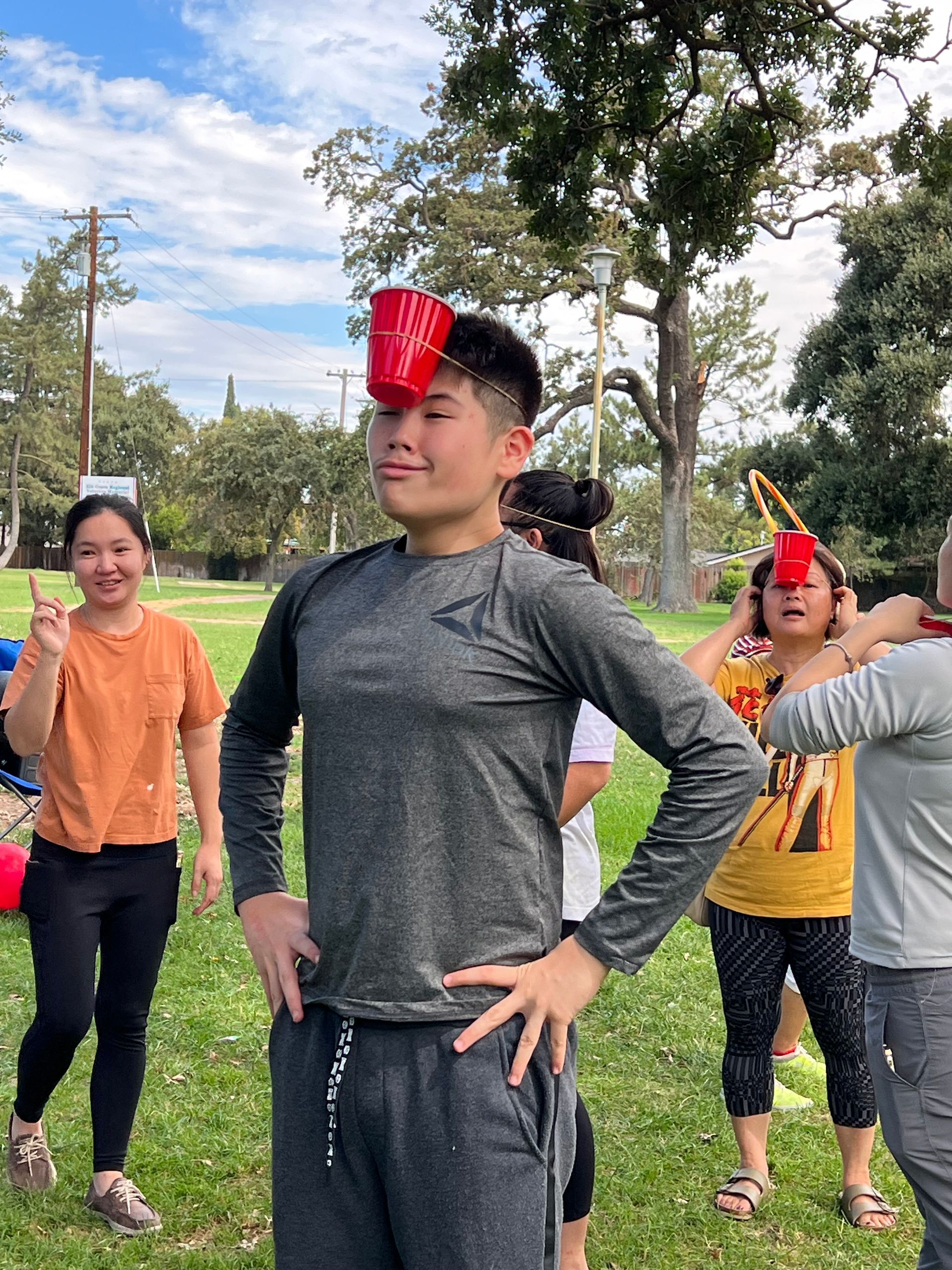 boy with cup on forehead