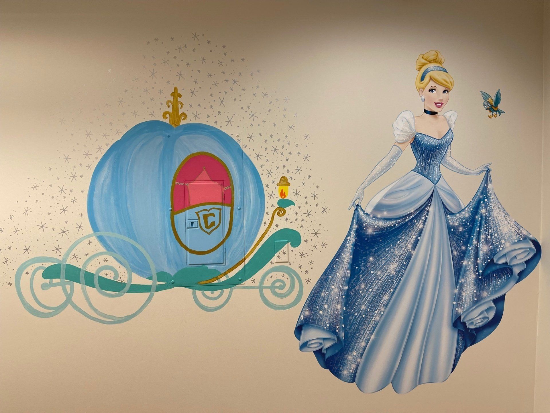 A painting of cinderella and her carriage on a wall