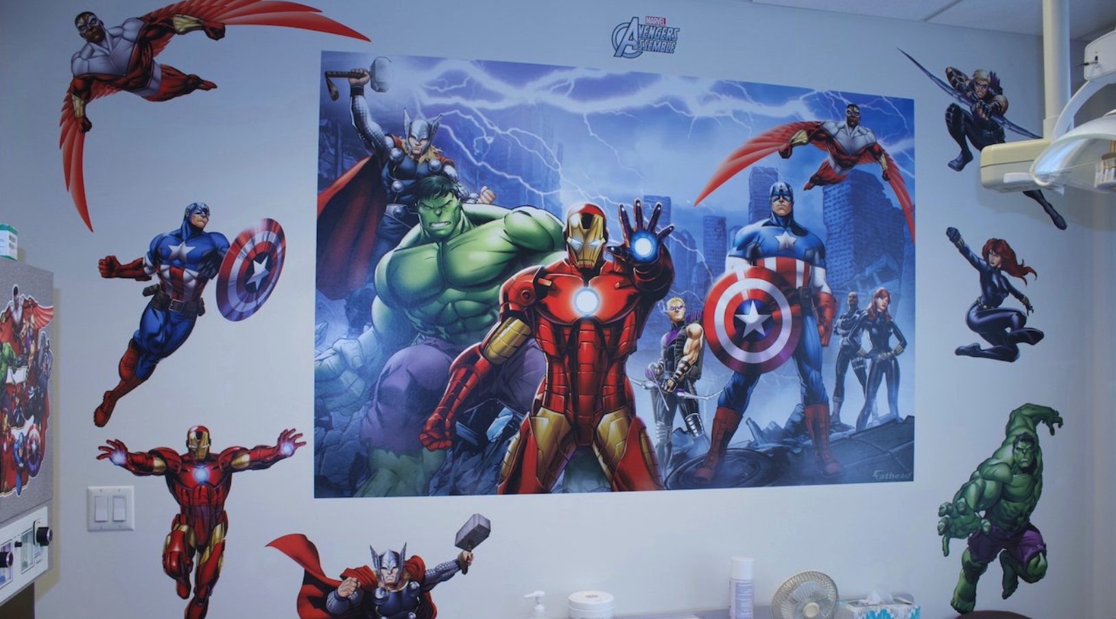 A wall with a picture of the avengers on it.
