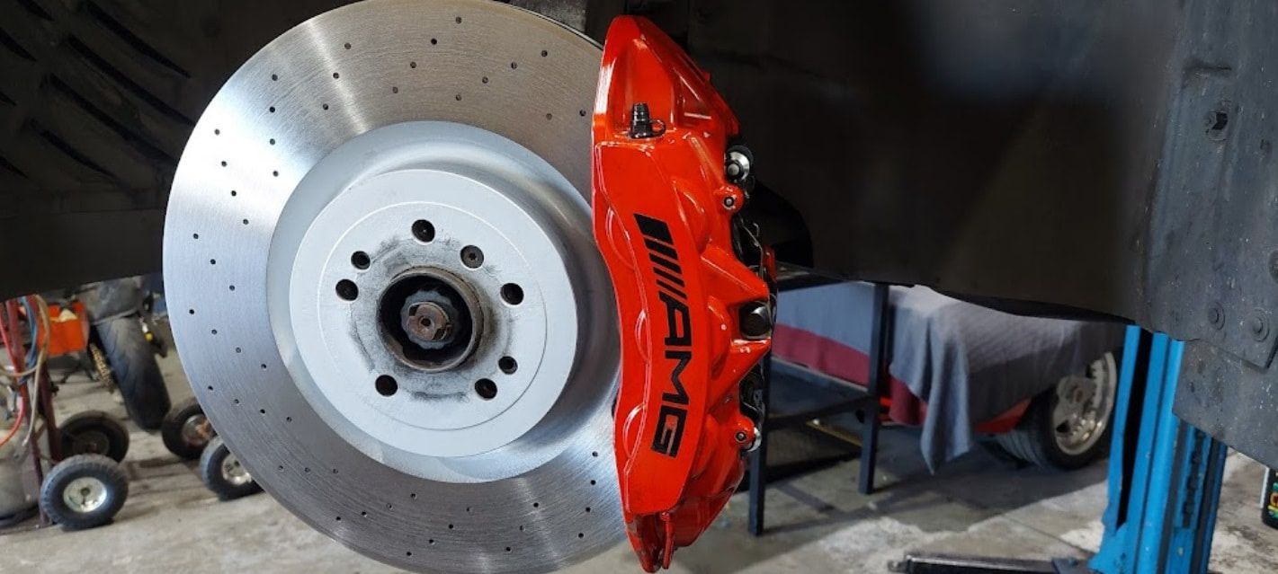 A Close Up Of A Brake Disc And Brake Caliper On A Car — Albion Park Auto Electrical & Mechanical In Albion Park Rail, NSW