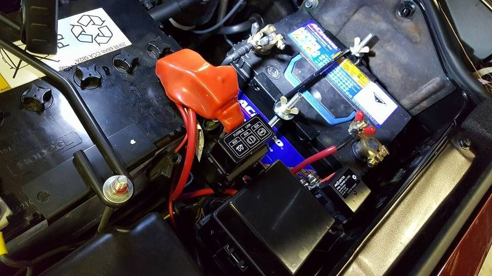 A Close Up Of A Car Battery With Red Wires Coming Out Of It — Albion Park Auto Electrical & Mechanical In Albion Park Rail, NSW