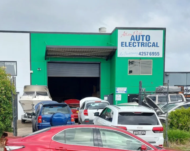 A Red Car Is Parked In Front Of A Building — Albion Park Auto Electrical & Mechanical In Albion Park Rail, NSW