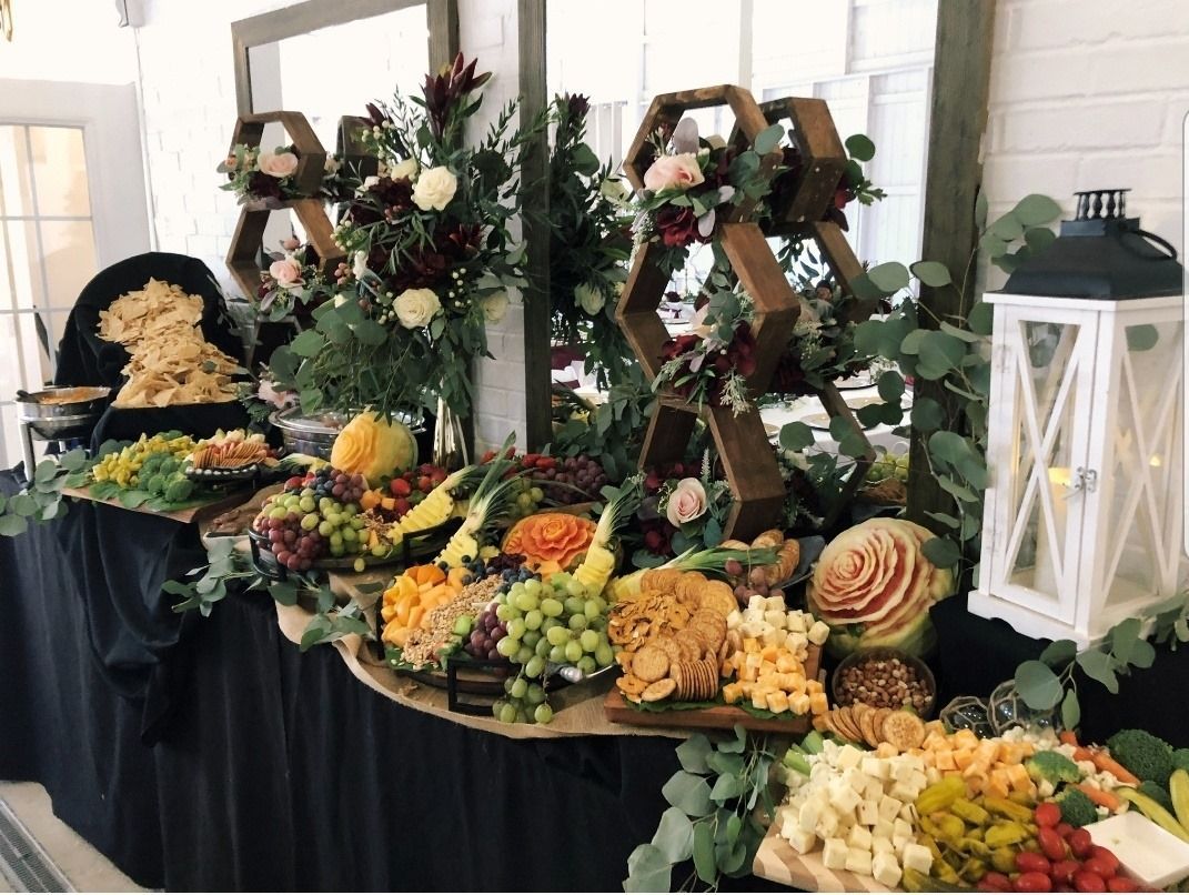 A buffet table filled with lots of fruits and vegetables.
