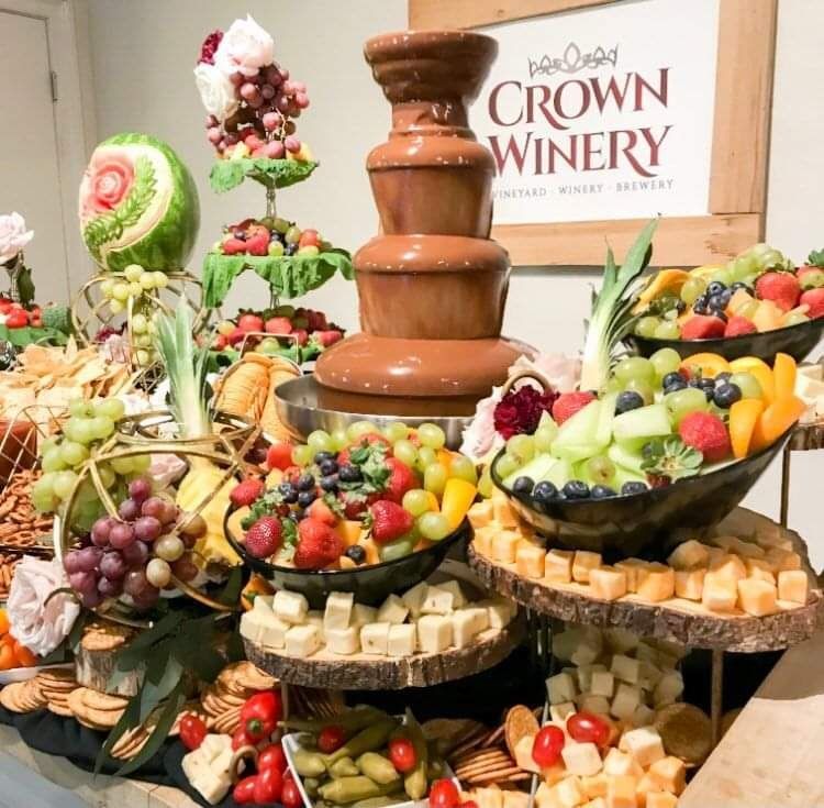 A buffet table with a sign that says crown winery