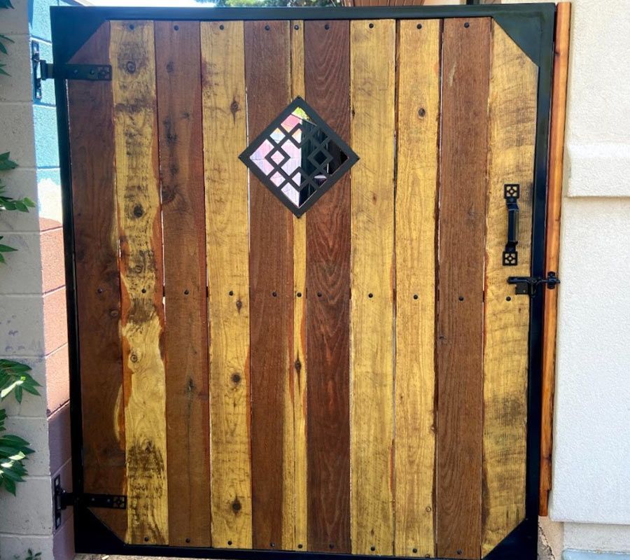 A wooden gate with a stained glass window on it