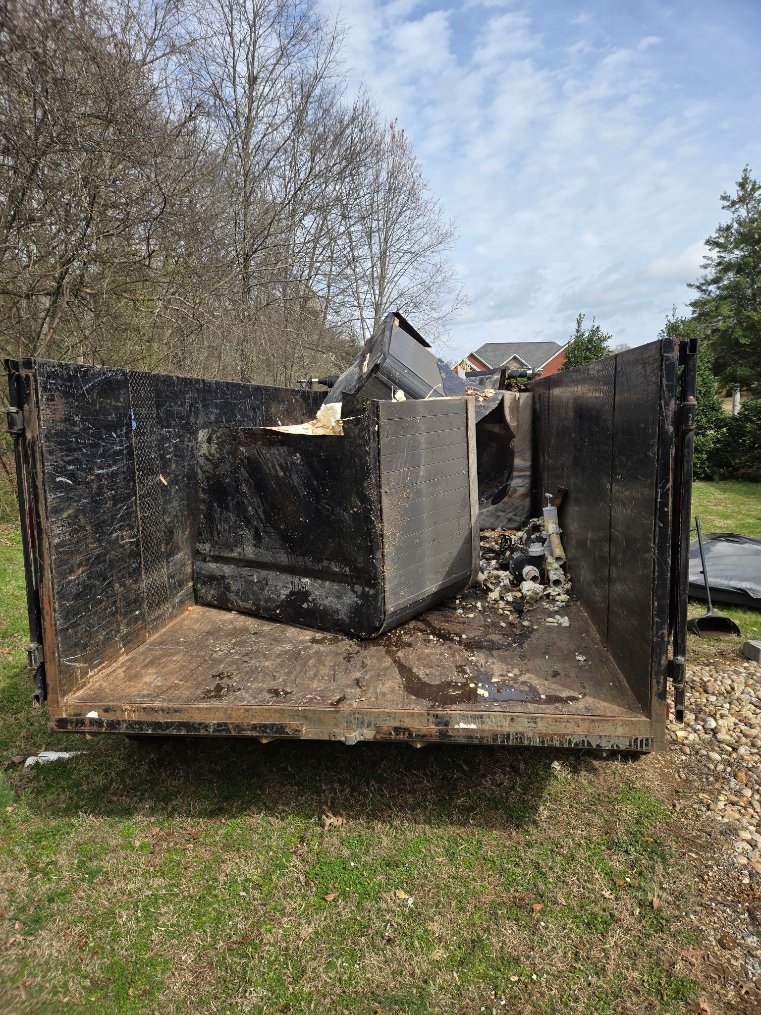 Removed hot tub in the back of a trailer.