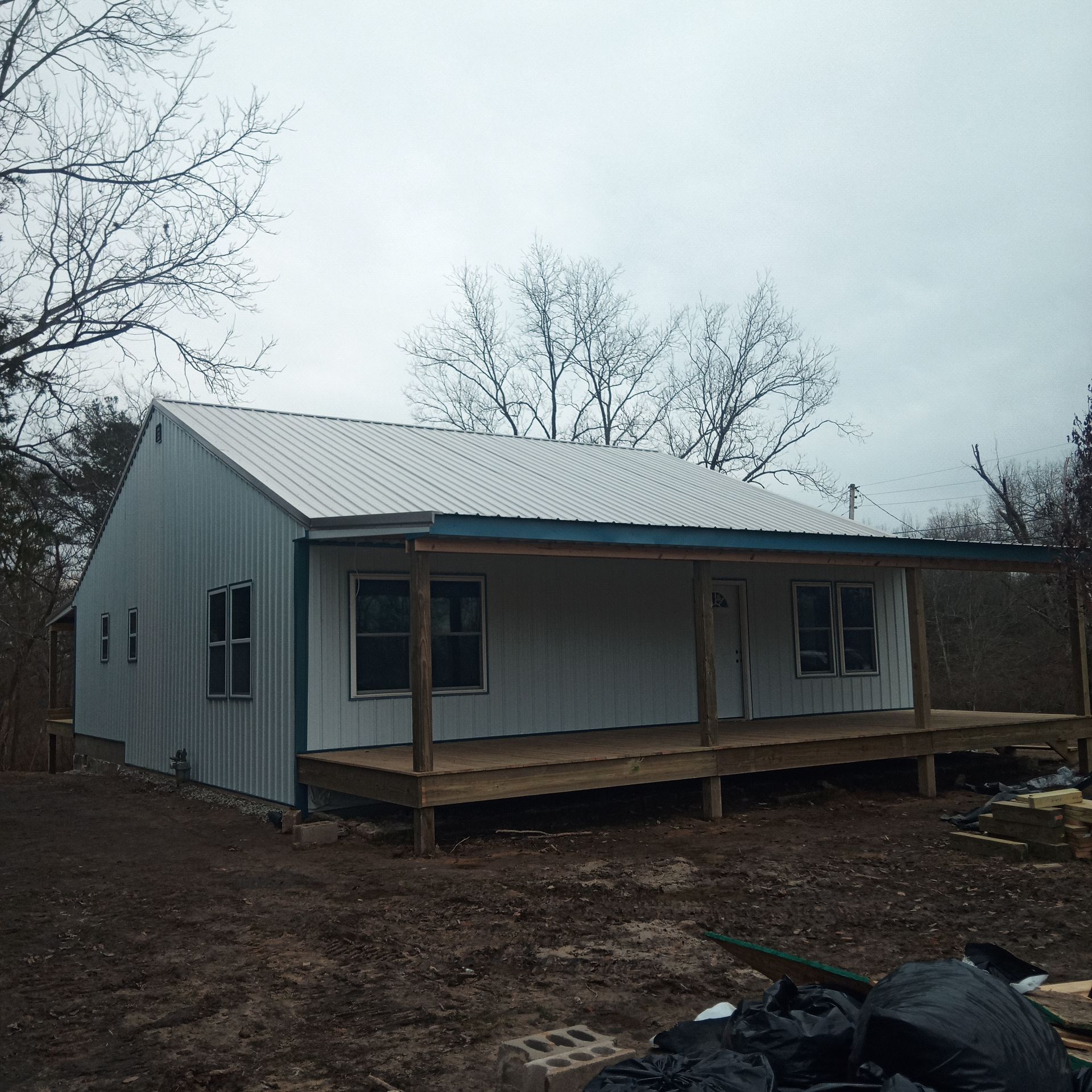 A white house with a blue trim and a porch